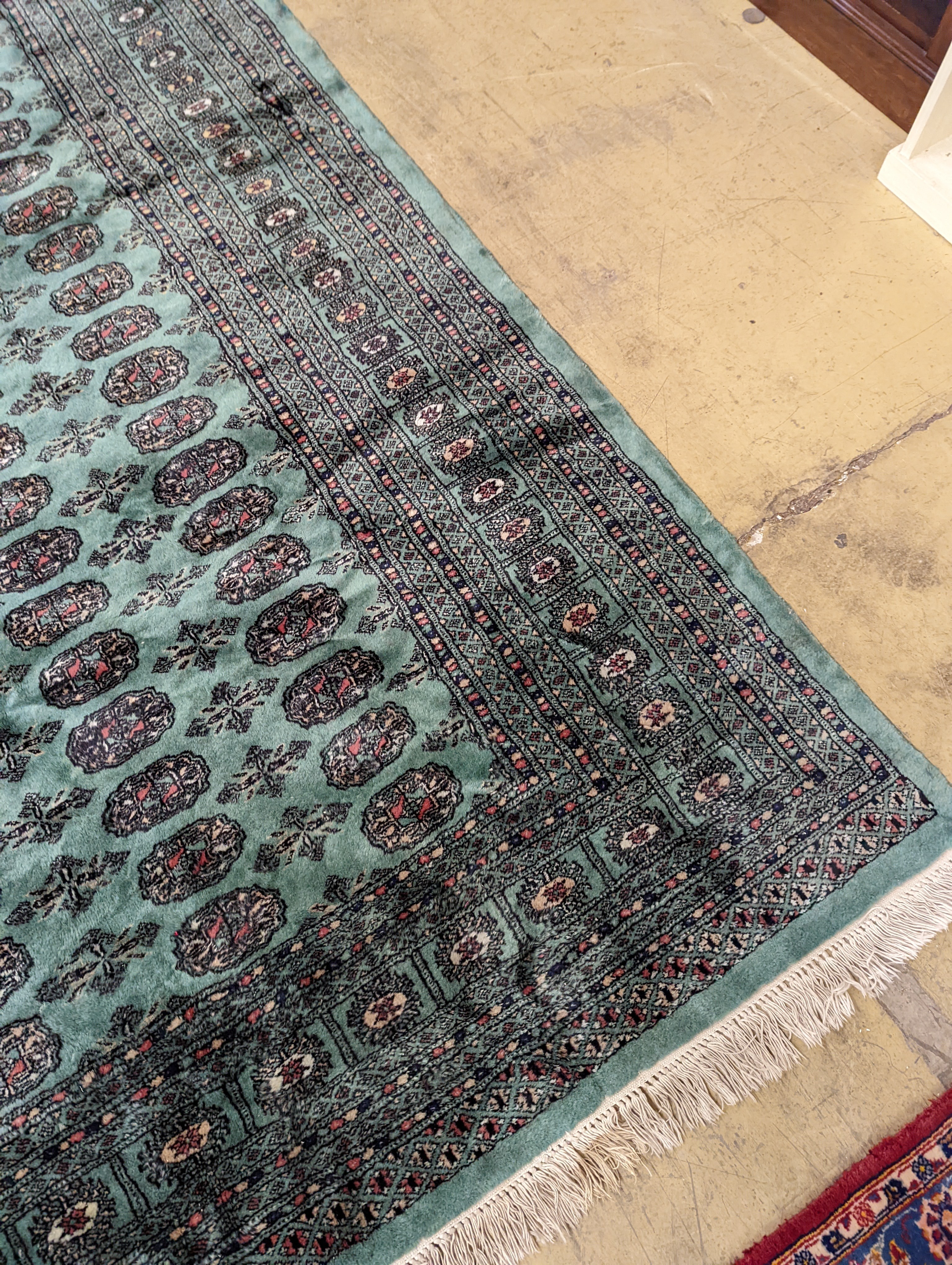 A Bokhara green ground carpet, 282 x 184cm